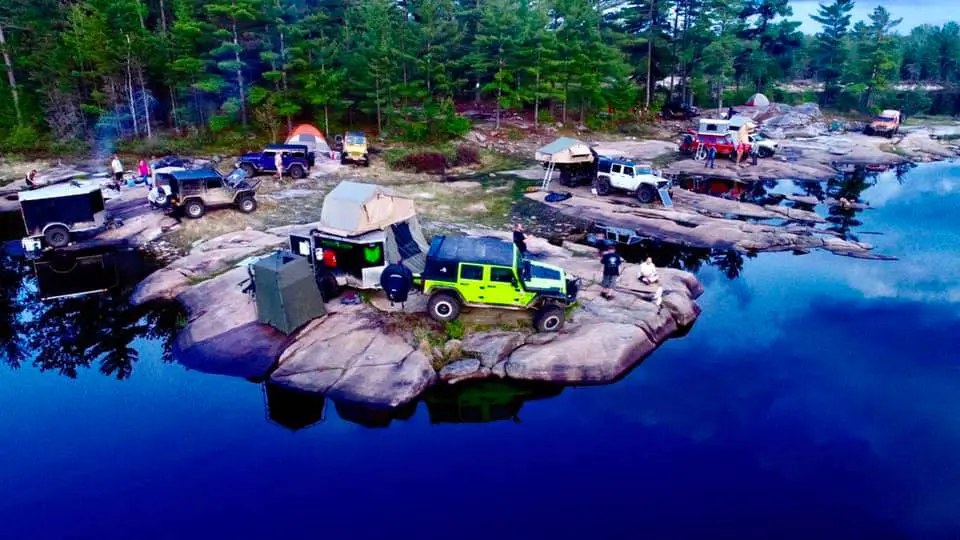 Jeeps with rooftop tent camping near water